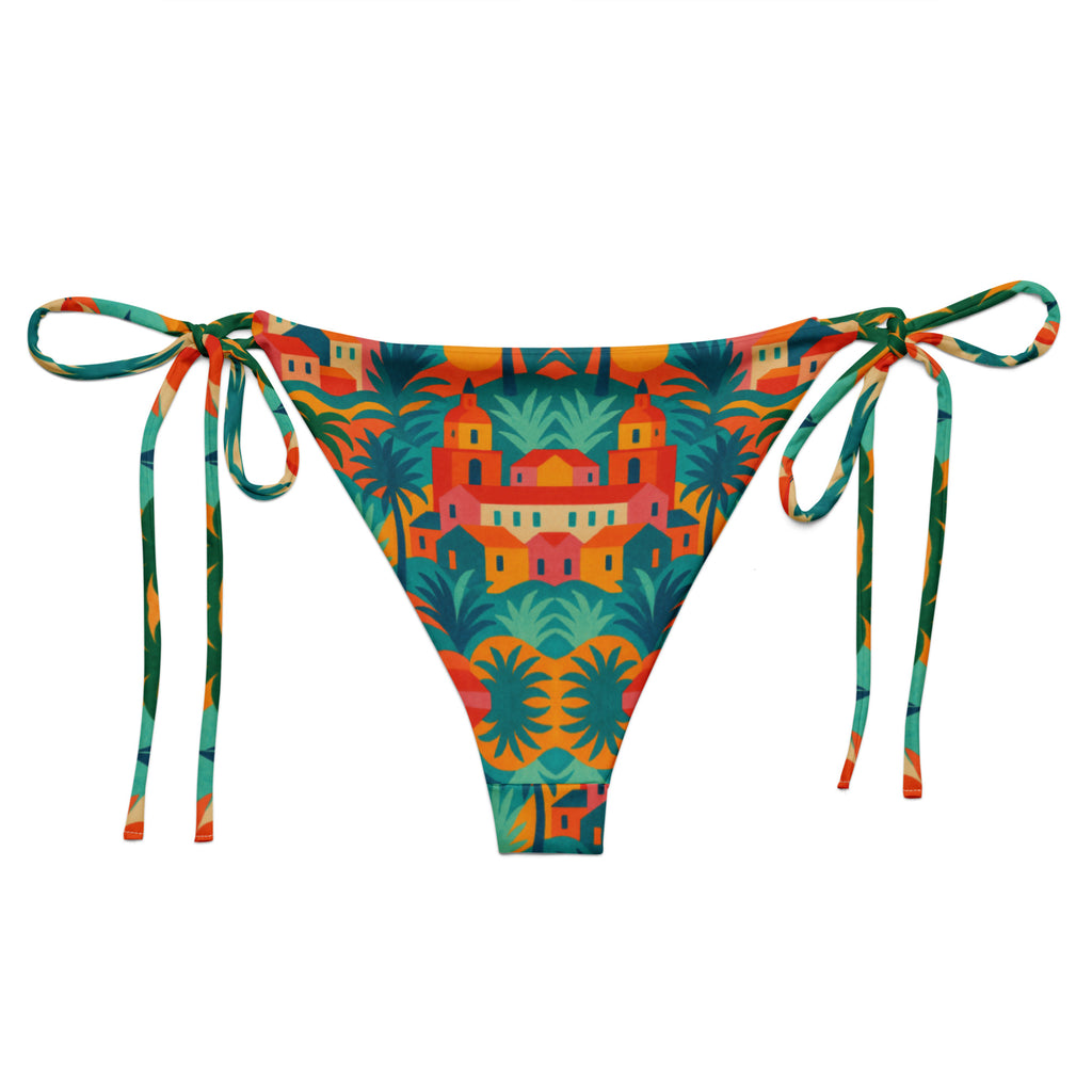Bas de bikini triangle luxe Rêve Riviera arriere en tissu recyclé, imprimé artistique inspiré de Saint-Tropez, présenté sur un lit de plage avec accessoires élégants.