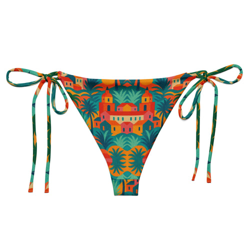 Bas de bikini triangle luxe Rêve Riviera arriere en tissu recyclé, imprimé artistique inspiré de Saint-Tropez, présenté sur un lit de plage avec accessoires élégants.