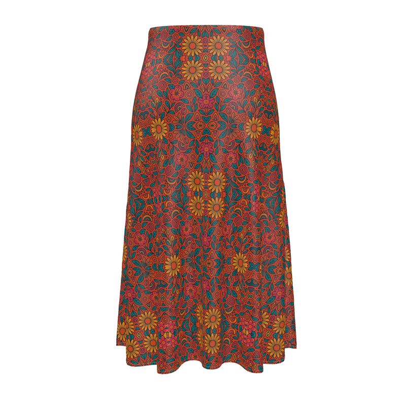 Jupe midi fluide imprimée aux motifs floraux solaires, coupe taille haute, portée par une femme en look bohème chic – Collection estivale Élisabeth Akaïa Kaï
