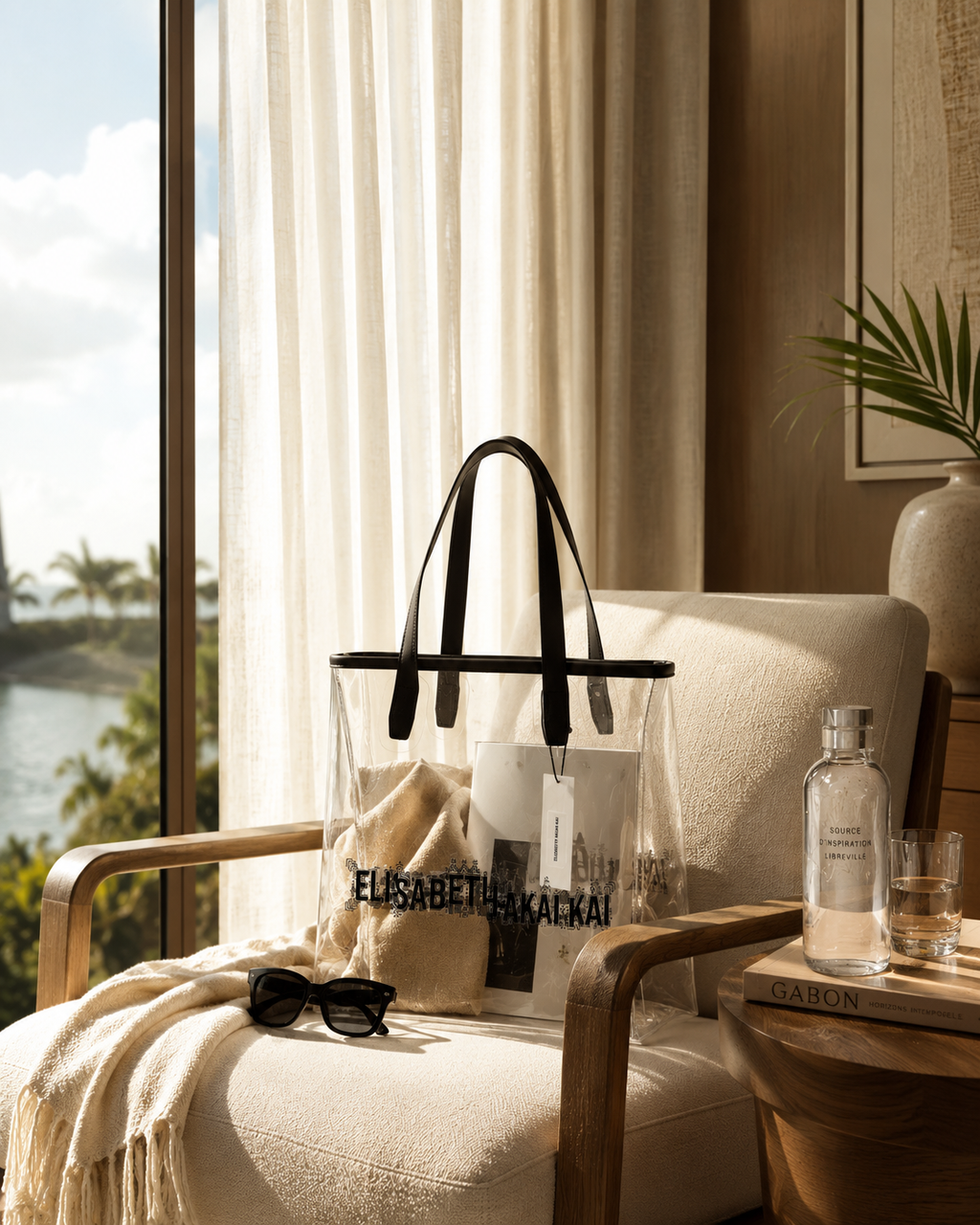 Le sac cabas transparent Elisabeth Akaia Kai s'invite dans une suite de luxe baignee de lumiere naturelle. Une creation haut de gamme inspiree du voyage, du raffinement et de l'art de vivre contemporain.