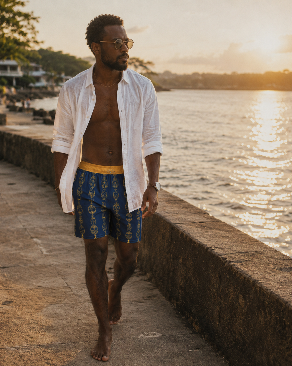 Le short Mebeghe Éternel accompagne les instants suspendus entre ville et océan. Une silhouette sophistiquée qui conjugue artisanat, héritage africain et luxe contemporain.