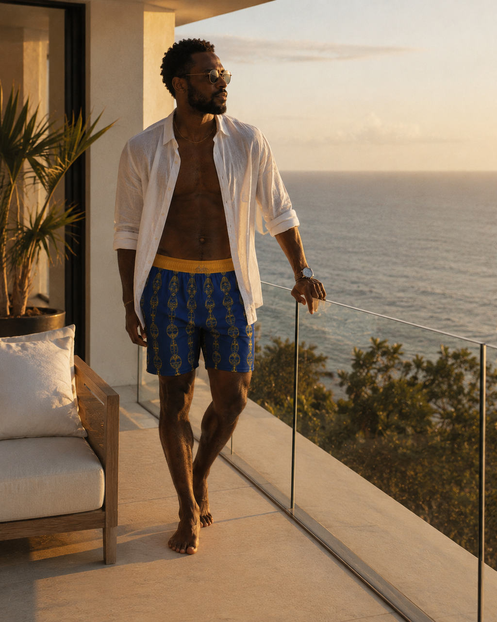 Porté sur une terrasse surplombant l'océan, le short Mebeghe Éternel illustre une esthétique Afro-Luxe moderne. Une pièce de créateur pensée pour les voyageurs en quête d'élégance et d'exclusivité.