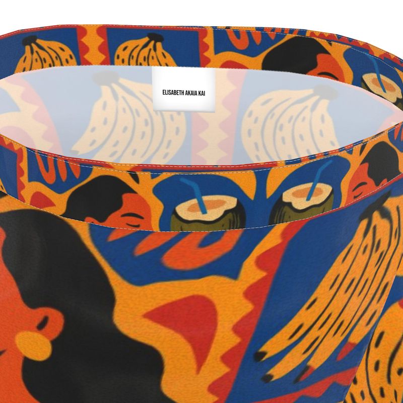 Jupe portefeuille Isla Sol signée Élisabeth Akaïa Kaï, en crêpe fluide imprimé, coupe bohème chic avec volants et ceinture nouée, disponible en version courte ou midi.