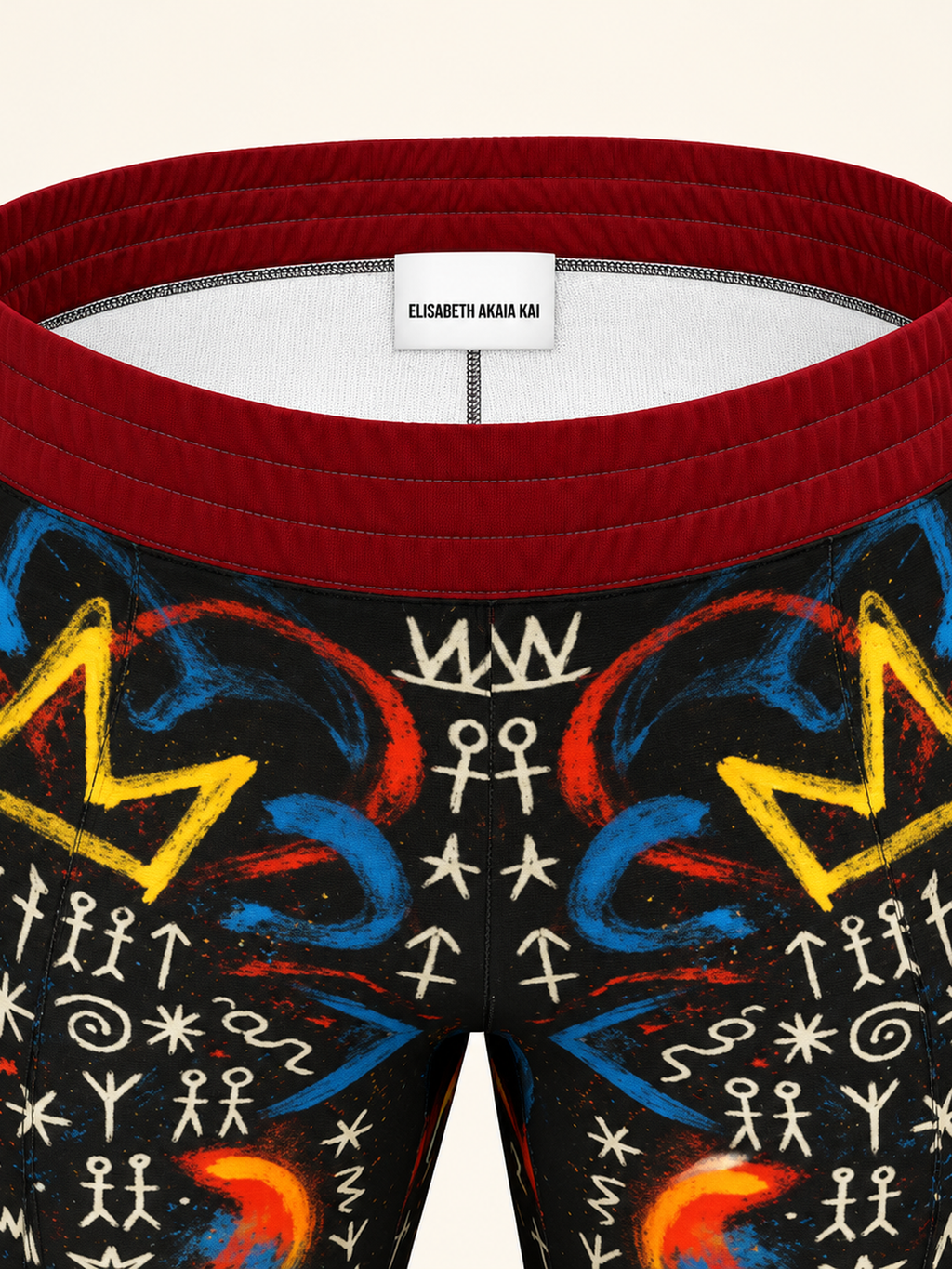 Détail de la ceinture bordeaux du pantalon MIENGO SEKIANI, finition de la taille et motif artistique du tissu.
